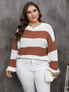 Detailed knit texture of plus size striped sweater in contrasting white and tan colors
