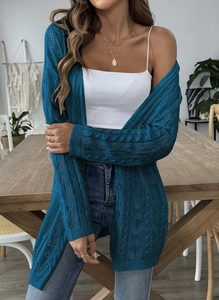 Detail of teal crochet cardigan showing diamond hollow knit and cable stitch patterns