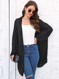 Detail of black crochet knit cardigan featuring openwork and cable texture for casual style
