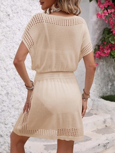 Detailed back view of beige hollow-out knit beach cover-up dress with waist silhouette