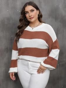 Detailed close-up of soft knit texture and orange striped pattern on women's sweater
