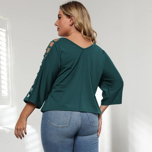 Detail view of the elegant dark green V-neck top with hollow mesh sleeves for plus size women