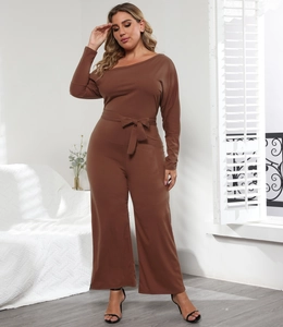Detail view of a brown off-shoulder jumpsuit featuring a long sleeve design and waist tie