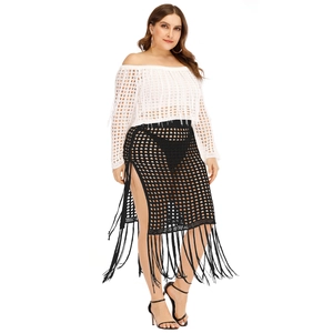 Crochet two-piece set featuring white off-shoulder top and black fringe skirt with side slit