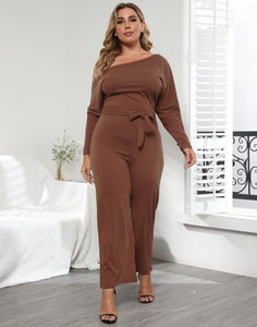 Detail of a brown off-the-shoulder jumpsuit featuring a waist tie and wide leg silhouette