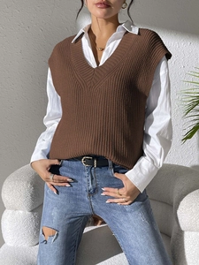 Detail of dark brown V-neck knit vest with thick textured stitch and sleeveless design
