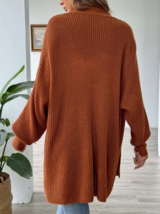 Back view of a loose caramel knit cardigan with drop shoulders and soft texture