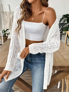 Detailed macro view of white crochet knit pattern and openwork texture of women's cardigan