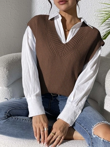 Women's V-neck brown knitted vest styled with a white button-down shirt for a casual look