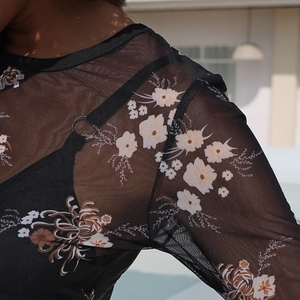 Detail of floral print mesh top with sheer texture and inner camisole with metal ring