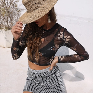 Detail of floral print mesh top and metallic openwork skirt with drawstring waist