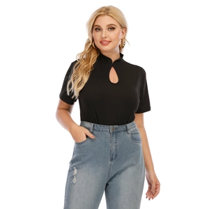 Plus size black mandarin collar cutout top with distressed light blue jeans