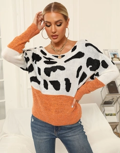 Women's crewneck color block knit sweater with animal print and orange sleeves