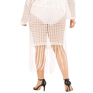 Detail view of white crochet skirt featuring long tassels and boho hollow knit pattern