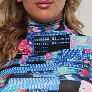 Close-up of high neck digital glitch art print top with vibrant colors and typography