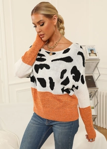Detail of three-color knit sweater featuring animal print and orange patchwork texture