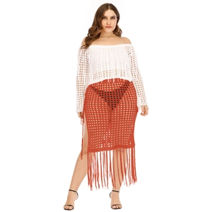 Detail of crochet knit beach skirt with long tassels and side tie-up cutout design