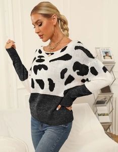 Detail shot of the knit texture and animal print pattern on this women's sweater