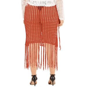Close-up of the reddish-brown crochet knit skirt with hollow-out mesh and long fringe detail