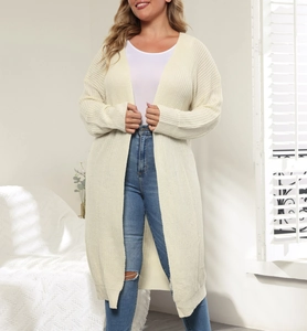 Detail shot of beige long knitted cardigan with high-quality thick woven texture