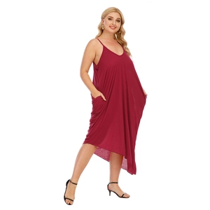 Detail of plus size V-neck dress showing deep red fabric and functional side pockets