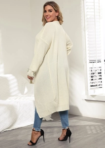 Detail of cream-colored long knit cardigan with textured fabric and ribbed cuffs style