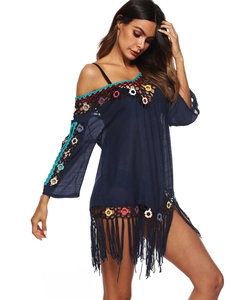 Detailed view of bohemian navy beach dress featuring colorful crochet rings and long tassels