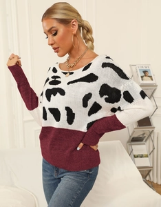 Close-up of leopard print and burgundy knit panel with ribbed round neckline detail