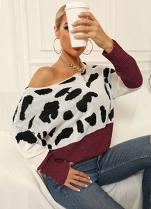 Close-up of leopard print knit sweater with burgundy trim and off-shoulder neckline