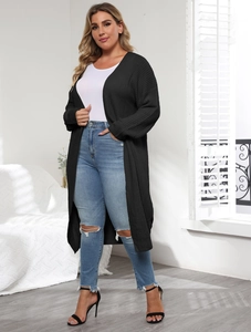 Detail of a black long knit cardigan featuring thick knit texture and an open front design