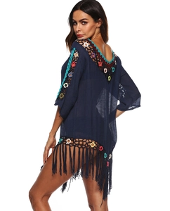 Detail of dark blue bohemian beach cover-up featuring colorful crochet and long tassels