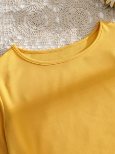 Bright yellow crew neck T-shirt with burnout hollow out back and casual loose fit