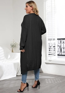 Detail view of long black knit cardigan with oversized fit and dropped shoulder style