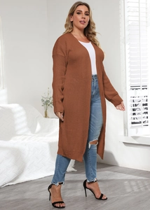 Detail of a brown long knit cardigan showing textured weave and slim fit over casual wear