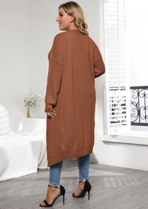 Detail of caramel brown knit cardigan showing ribbed cuffs and textured thick woven fabric