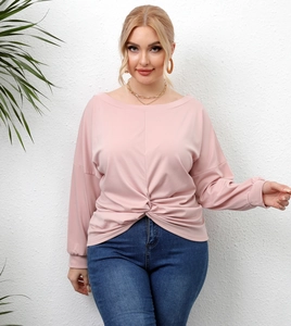 Detailed view of the knotted hem design on a pink plus size long sleeve tunic top