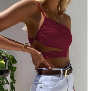 Detail of burgundy asymmetrical crop top with pleated front and side cut-out design