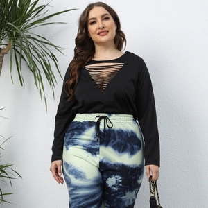 Detail of plus size long sleeve top with laser-cut V-neckline and tie-dye joggers