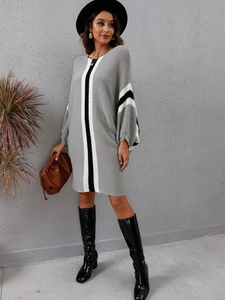 Detail of color-block knit dress with batwing sleeves and vertical stripe texture