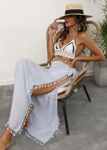 Bohemian beach set with white crochet bikini top and light blue fringe wrap skirt