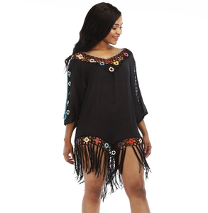 Detail of V-neck crochet border and tassels on black beach cover-up dress
