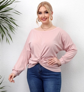 Detail of pink plus size top featuring a front knot design and off-shoulder neckline