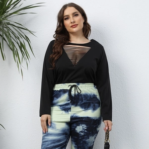 Close-up of black long sleeve top with sexy triangle cutout and tie-dye joggers