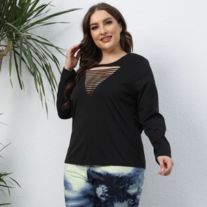 Detail of plus size black top featuring V-shaped cutout ladder design and long sleeves