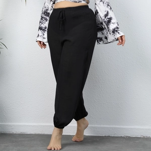 Detail of black cotton linen joggers showing elastic drawstring waist and textured fabric
