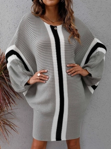 Close-up detail of knitted dress showing color block patterns and thick texture