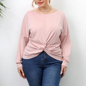 Detail of light pink plus size tunic with off-shoulder neckline and twist knot front design