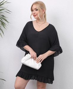 Detail of V-neck black beach cover-up dress featuring ruffled hem and textured fabric