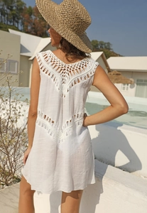 Detail of white crochet hollow-out back and waist design on V-neck sleeveless beach cover-up