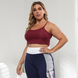 Close-up of ribbed dark red crop top and multi-color patchwork high waist leggings